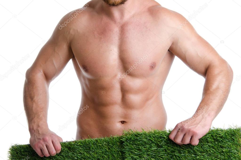 Young sexy man holding a lawn.