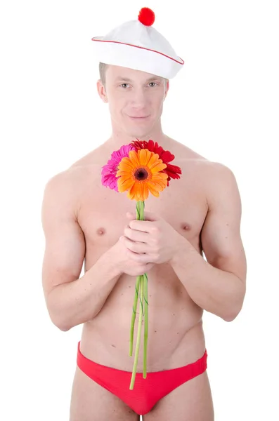 Jóképű férfi és a virágok. — Stock Fotó