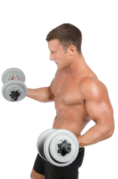 Gym. Attractive athletic man shirtless holding dumbbells. — Stock Photo, Image