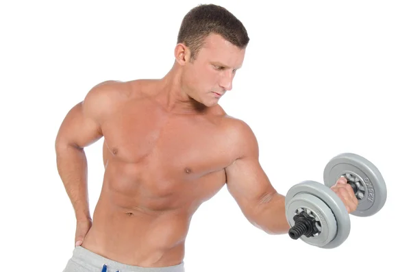 Gym. Attractive athletic man holding a dumbbell. — Stock Photo, Image