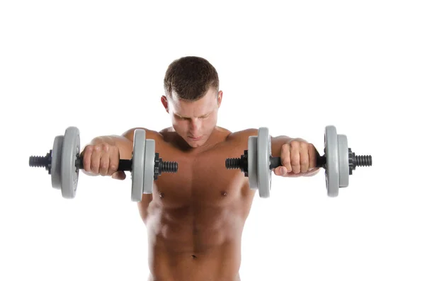 Gym. Attractive athletic man shirtless holding dumbbells. — Stock Photo, Image