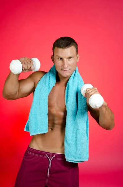 Vintage gym. Guy with white dumbbells. — Stock Photo, Image