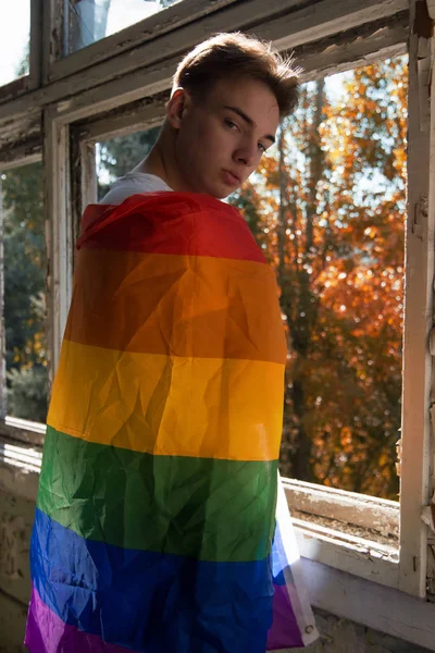 The struggle for their rights. Equality and freedom. Young attractive guy with a gay flag.