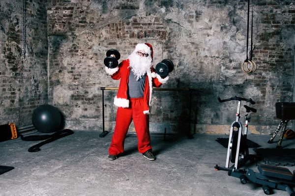 Fitness. Funny Santa Claus and gym.