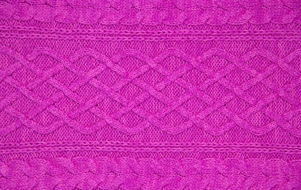 Pink wool yarn of knitted texture. Hand knitting. Close up. Pink background. — 스톡 사진