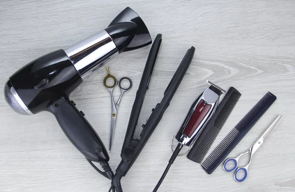 Hair cutting tools lie on a wooden background. Hair clipper. Hair clipper.