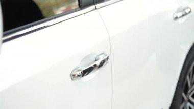 Bir jipin kapısını açan bir adamın eli.