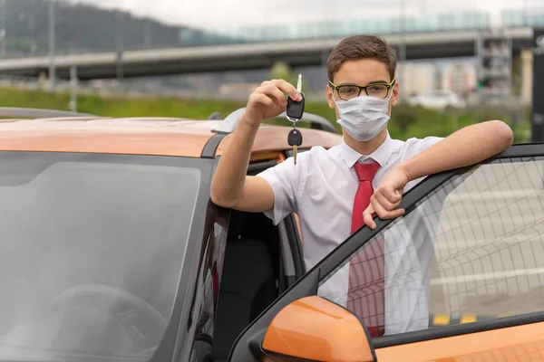 Concept of a personal driver service. Chauffeur-drive. Personal chauffeur in a protective face mask