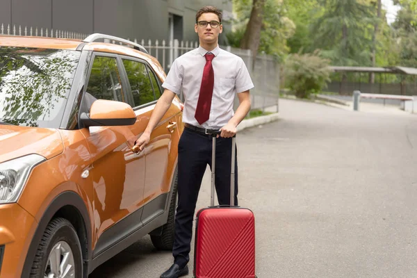 Transport and transfer concept. Business trip for young businessman getting into car