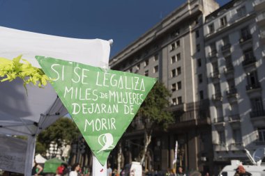 Capital Federal, Buenos Aires / Argentina; Feb 19, 2020: If legalized, thousands of women will stop dying, green scarf-shaped poster, in favor of approval of the law for legal, safe and free abortion