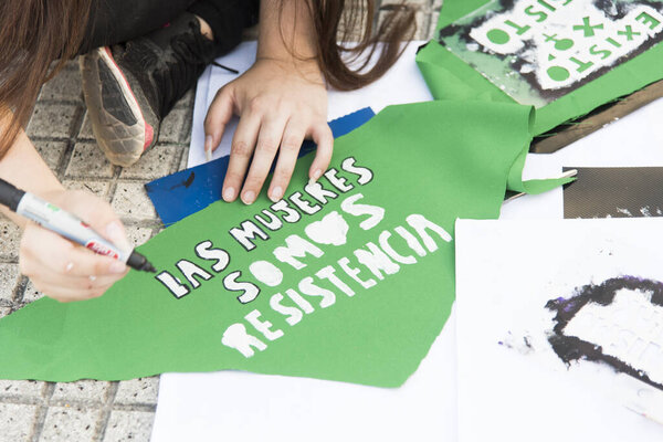 Capital Federal, Buenos Aires / Argentina; Feb 19, 2020: preparations for a rally in favor of legal, safe and free abortion; green handkerchief in which they write a message: women are resistance