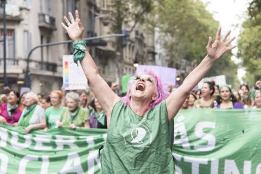 CABA, Buenos Aires / Argentina; March 9, 2020: international women's day. Expressive woman marching in support of the approval of the law of legal, safe and free abortion