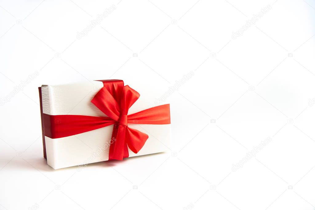 Beautiful Christmas gift box with red ribbon on isolated background. Happy New Year and merry christmas. 