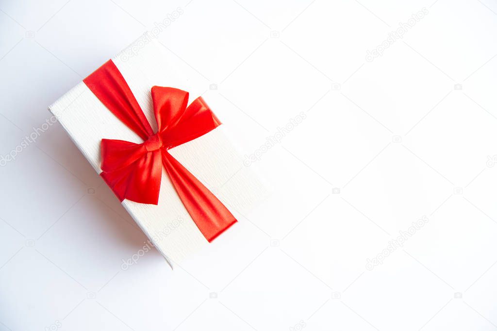 Beautiful Christmas gift box with red ribbon on isolated background. Happy New Year and merry christmas. 