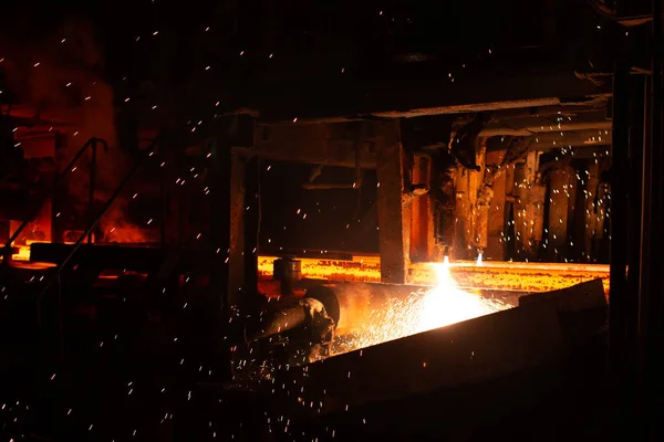 Hot red steel billets at torch cutting. Background of the blacksmith and metallurgical industry. Stock Photo