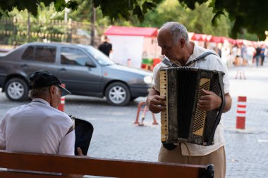 Chernivtsi, Ukrayna, 25.08.2019: Eski şehrin yaya caddesinde iki eski müzisyen düğme akordeon çalıyor