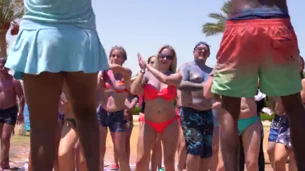 Hurghada, Egypt, 09.08.2019: International tourists are dancing on choreography with songs at the beach — Stock Video