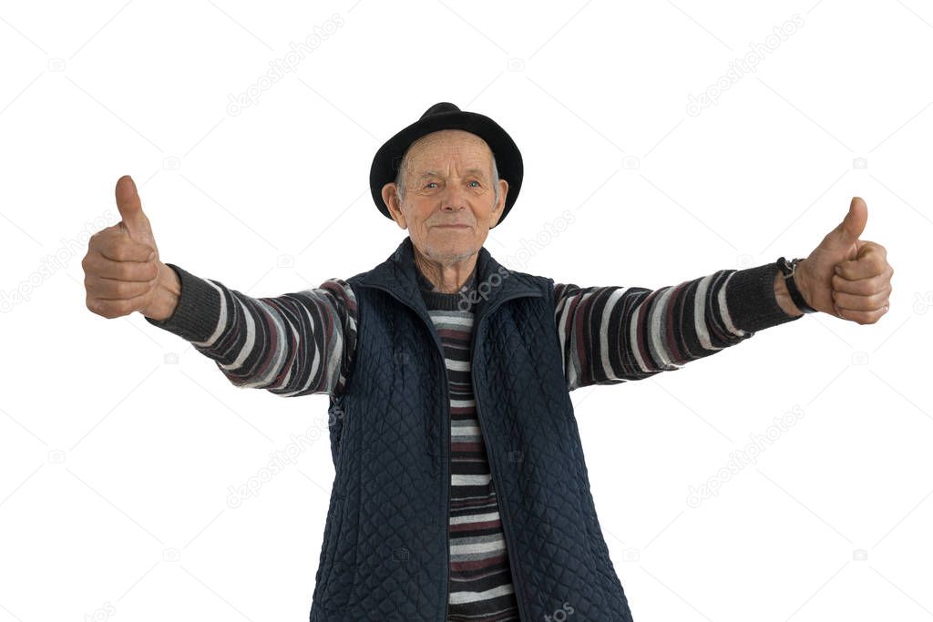 Confident, calmy senior european man with double thumbs up gesture, dressed in casual clothes and black hat, looking at the camera isolated over white background