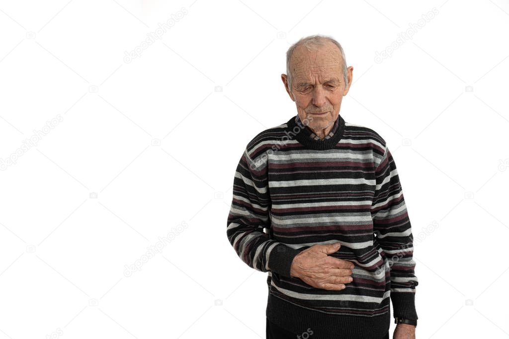 Old mature man in casual clothes overwhelmed with a pain in the stomach isolated on white background, copyspace for your text