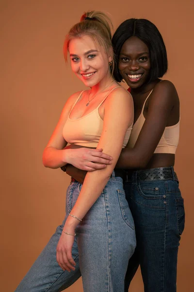 Happy lesbian international couple in casual clothes, african girl hugging her european blonde girlfriend — Stockfoto