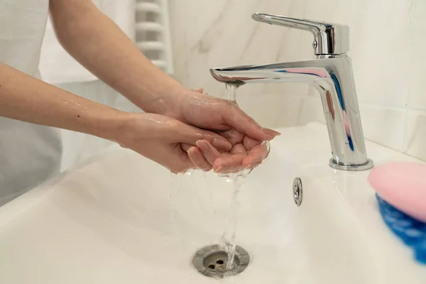 Foto da vicino di una donna che si risciacqua le mani dopo il lavaggio con sapone — Foto Stock