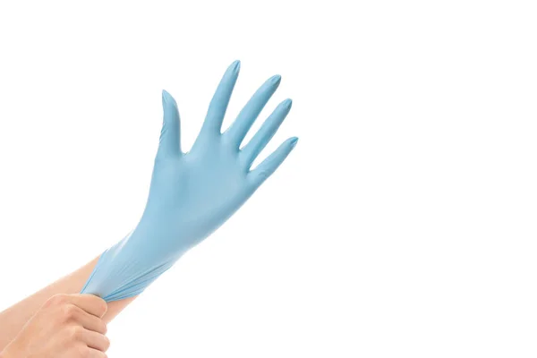 Vrouw met blauwe beschermende handschoen op haar hand, geïsoleerd op witte achtergrond — Stockfoto