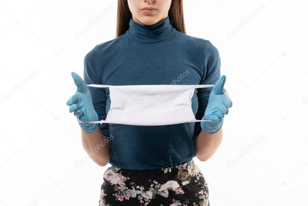 Doctor or nurse holding in hands with gloves face mask on white background.