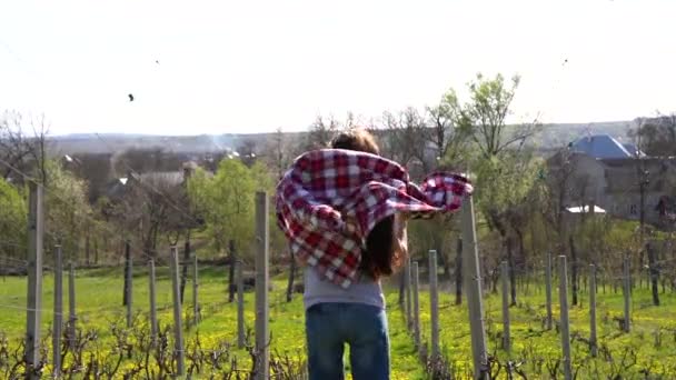 Happy female in casual clothes enjoying sunny spring day in the village — Stock Video