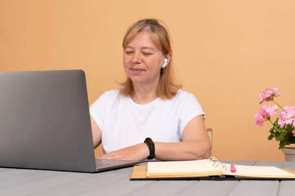 Cabeça tiro agradável mulher de meia-idade feliz freelancer trabalhando no computador em casa — Fotografia de Stock