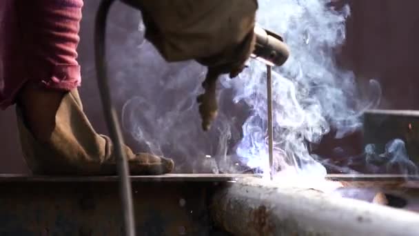 Welder works in metal construction - construction and processing of steel components — Stock Video