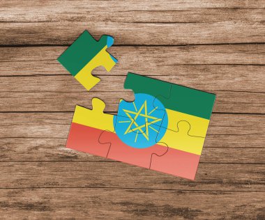 Yapboz üzerinde Etiyopya ulusal bayrağı. Bir parçası eksik. Tehlike kavramı.