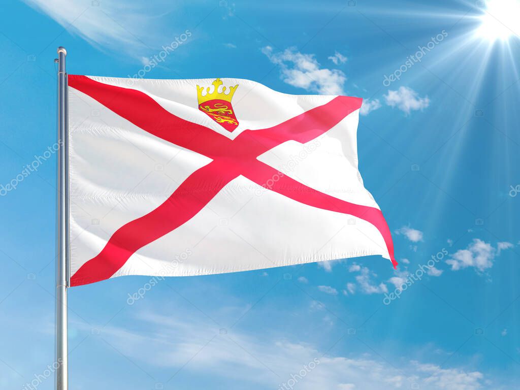 Jersey national flag waving in the wind against deep blue sky. High quality fabric. International relations concept.