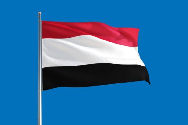Yemen national flag waving in the wind on a deep blue sky. High quality fabric. International relations concept. clipart