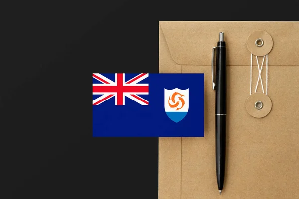 Anguilla flag on craft envelope letter and black pen background. National invitation concept. Invitation for education theme.