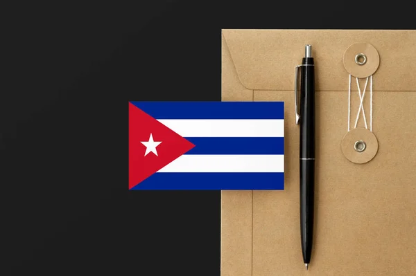 Cuba flag on craft envelope letter and black pen background. National invitation concept. Invitation for education theme.