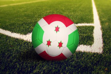 Burundi bayrağı köşe vuruşu pozisyonunda, futbol sahasında. Ulusal futbol teması yeşil çimlerde.