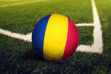 Çad bayrağı köşe vuruşu pozisyonunda, futbol sahasında. Ulusal futbol teması yeşil çimlerde.