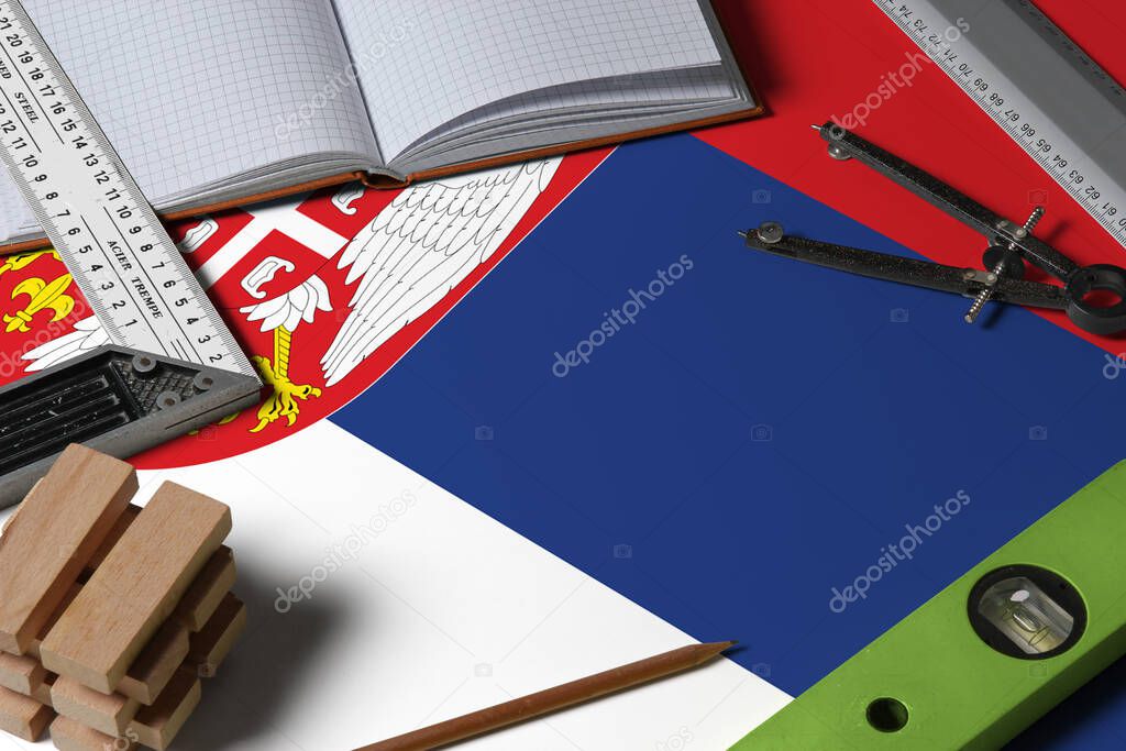 Serbia national flag on profession concept with architect desk and tools background. Top view mock-up.