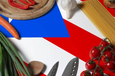 Puerto Rico flag on fresh vegetables and knife concept wooden table. Cooking concept with preparing background theme. clipart