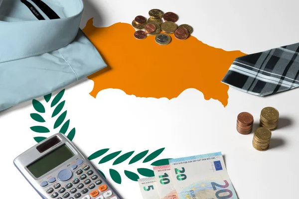 Cyprus flag on minimal money concept table. Coins and financial objects on flag surface. National economy theme.