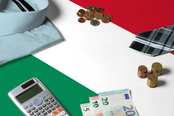 Hungary flag on minimal money concept table. Coins and financial objects on flag surface. National economy theme.