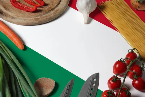Hungary flag on fresh vegetables and knife concept wooden table. Cooking concept with preparing background theme.