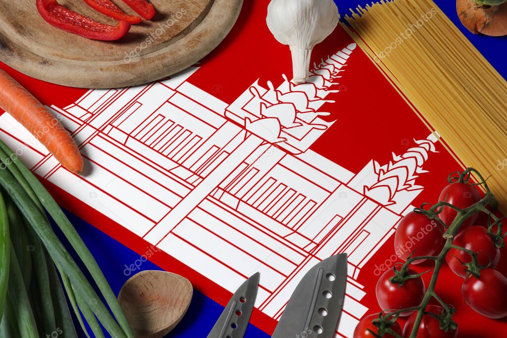 Cambodia flag on fresh vegetables and knife concept wooden table. Cooking concept with preparing background theme.