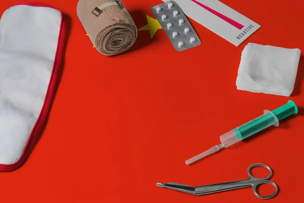 China flag with first aid medical kit on wooden table background. National healthcare system concept, medical theme.