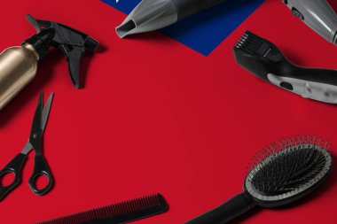 Saç kesme aletli Samoa bayrağı. Ulusal bir ahşap arka planda güzellik salonunun masasında taraklar, makas ve kuaför aletleri.