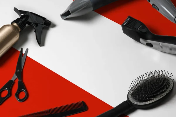 Austria flag with hair cutting tools. Combs, scissors and hairdressing tools in a beauty salon desktop on a national wooden background.