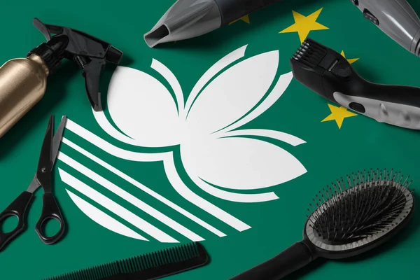 Macao flag with hair cutting tools. Combs, scissors and hairdressing tools in a beauty salon desktop on a national wooden background.
