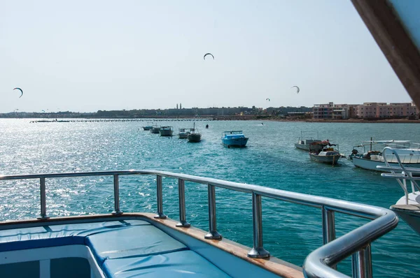 Blue sea and sea view from the deck of a white yacht. Egypt Hurghada. Boats, ships anchored off the coast. Summer and relaxation near the sea