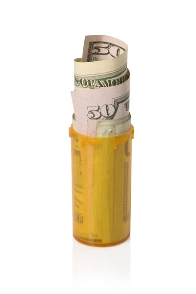 Money rolled up in Prescription container - Upright — Stock Photo, Image