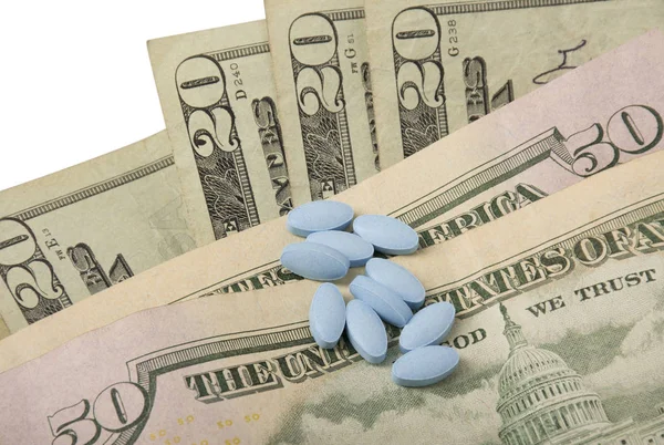 Blue Pills scattered on Money — Stock Photo, Image